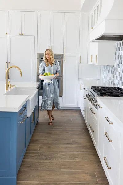 This kitchen combines style and functionality with its custom cabinetry, high-end appliances, and a spacious island, providing the perfect setting for culinary exploration.