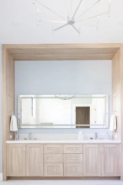 This elegant display showcases curated coastal-themed decor items within millwork shelving, adding a personalized touch to the living area.