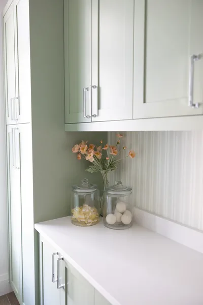 This corner of the kitchen emphasizes subtle elegance with pastel cabinetry and understated decor, creating a delightful and soothing space for everyday activities.